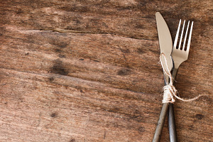 old fork and knife tied with a rope