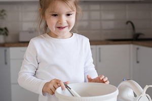 Child girl making cake