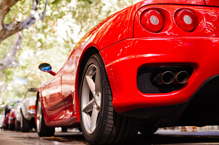 Back view of a red ferrari featuring fashion, car, and design