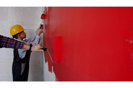 Family covering wall in bright red, a Person Photo by Barcelona_dreams