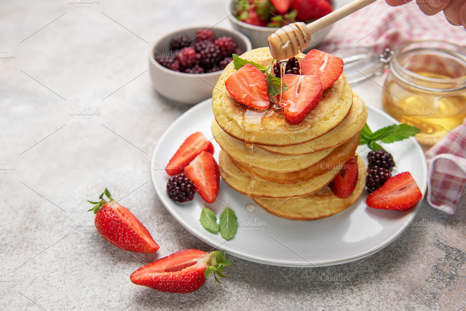 Stacked pancakes with strawberries, blackberries, and dripping h, a Food & Drink Photo by Olena Rudo
