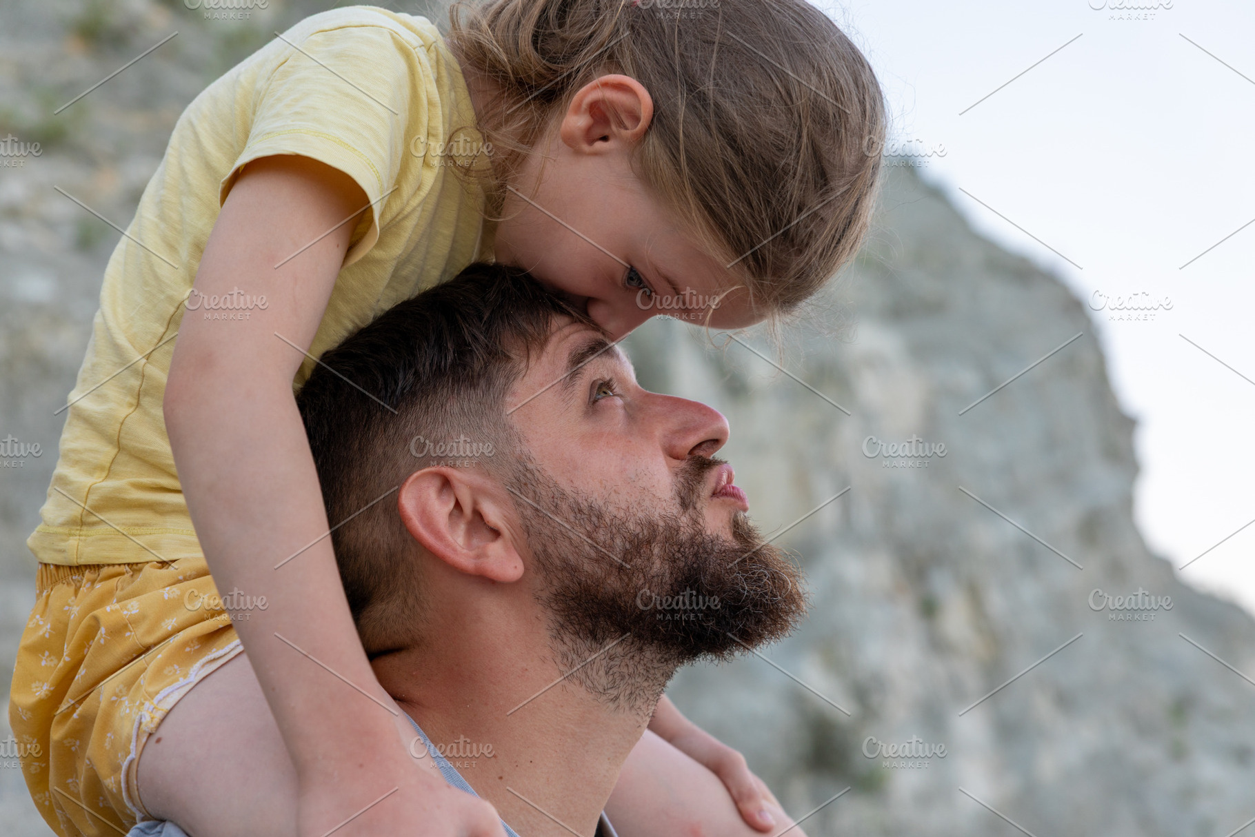 Young girl and her father share a tender moment outdoors, embracing affection a, a Person Photo by Ales Munt