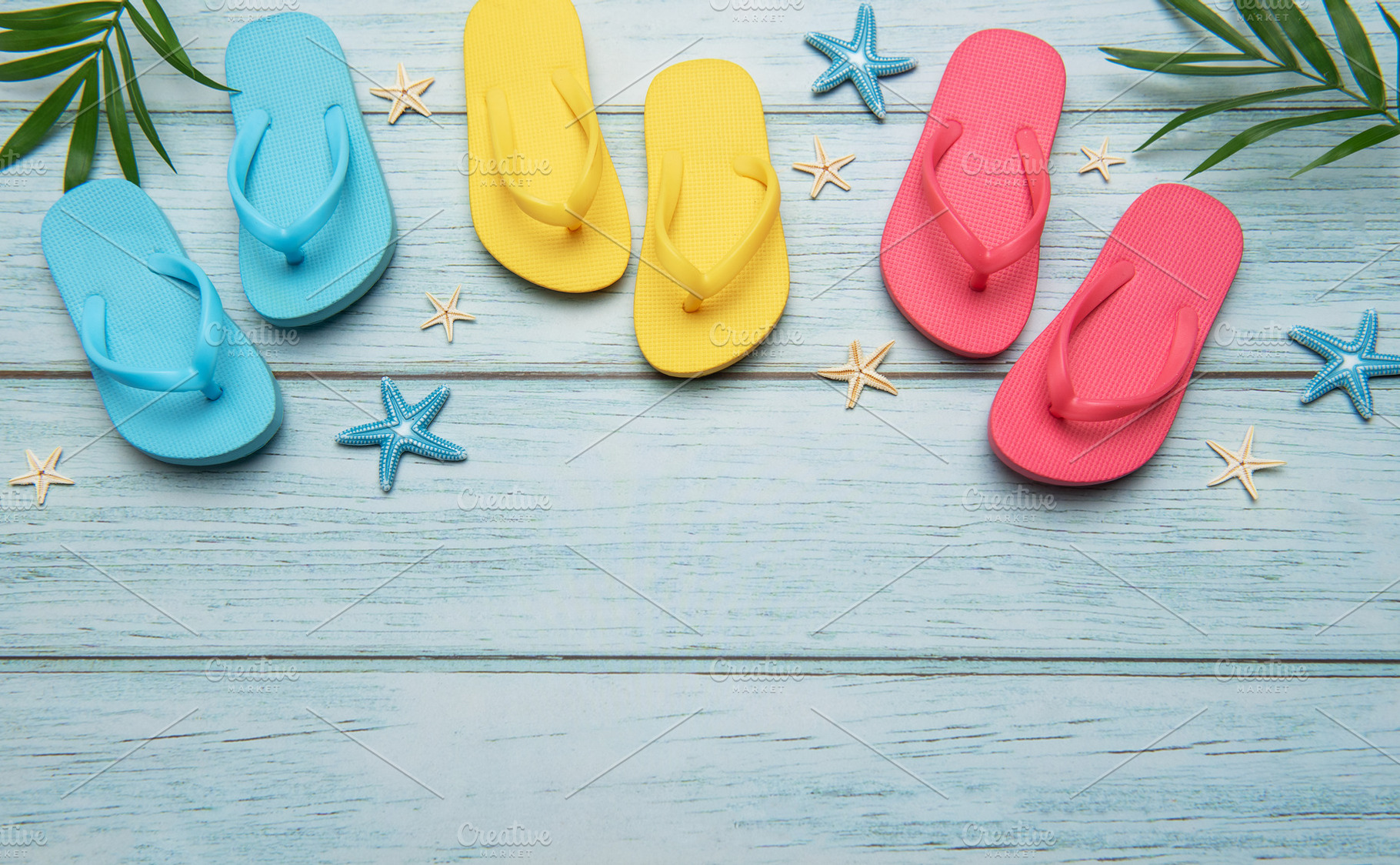 Colorful flip flops and starfish creating summer vacation atmosp, a Holiday Photo by Olena Rudo