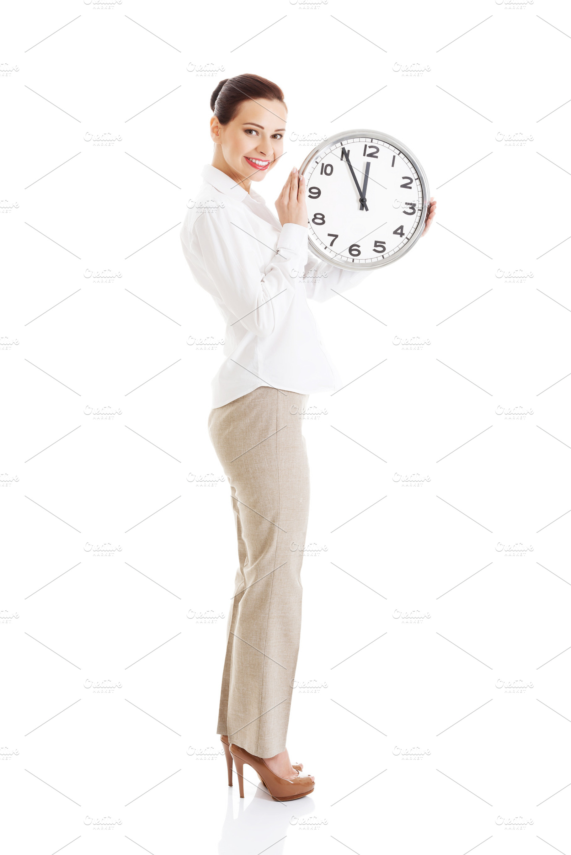 Young beautiful business woman holding clock containing business, clock, and, a Person Photo by PhotoMediaGroup