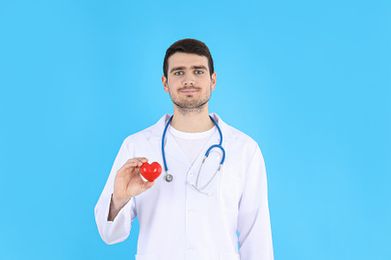 Doctor - intern with heart on blue background, a Person Photo by AtlasStudio PRO