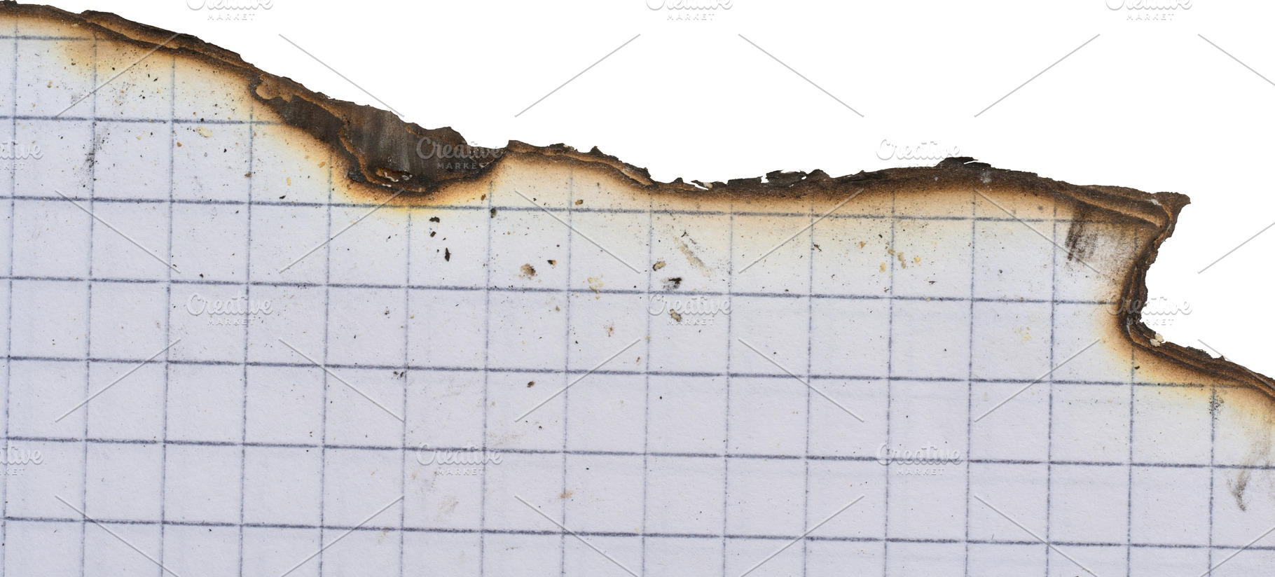 Sheet of white squared notebook paper with a badly burnt top edg, an Abstract Photo by ndanko