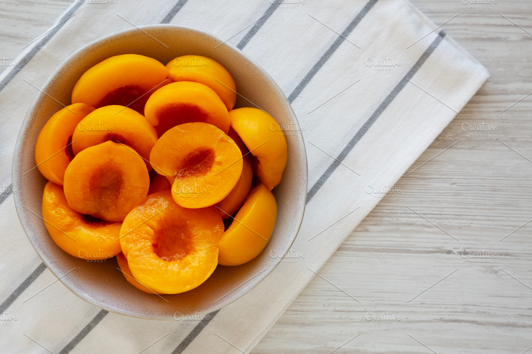 Healthy Organic Canned Peach Halves in a Bowl, top view., a Food & Drink Photo by LiudmylaChuhunova