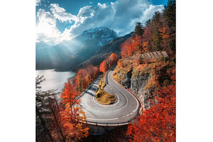 Aerial view of winding mountain road, a Transportation Photo by den-belitsky