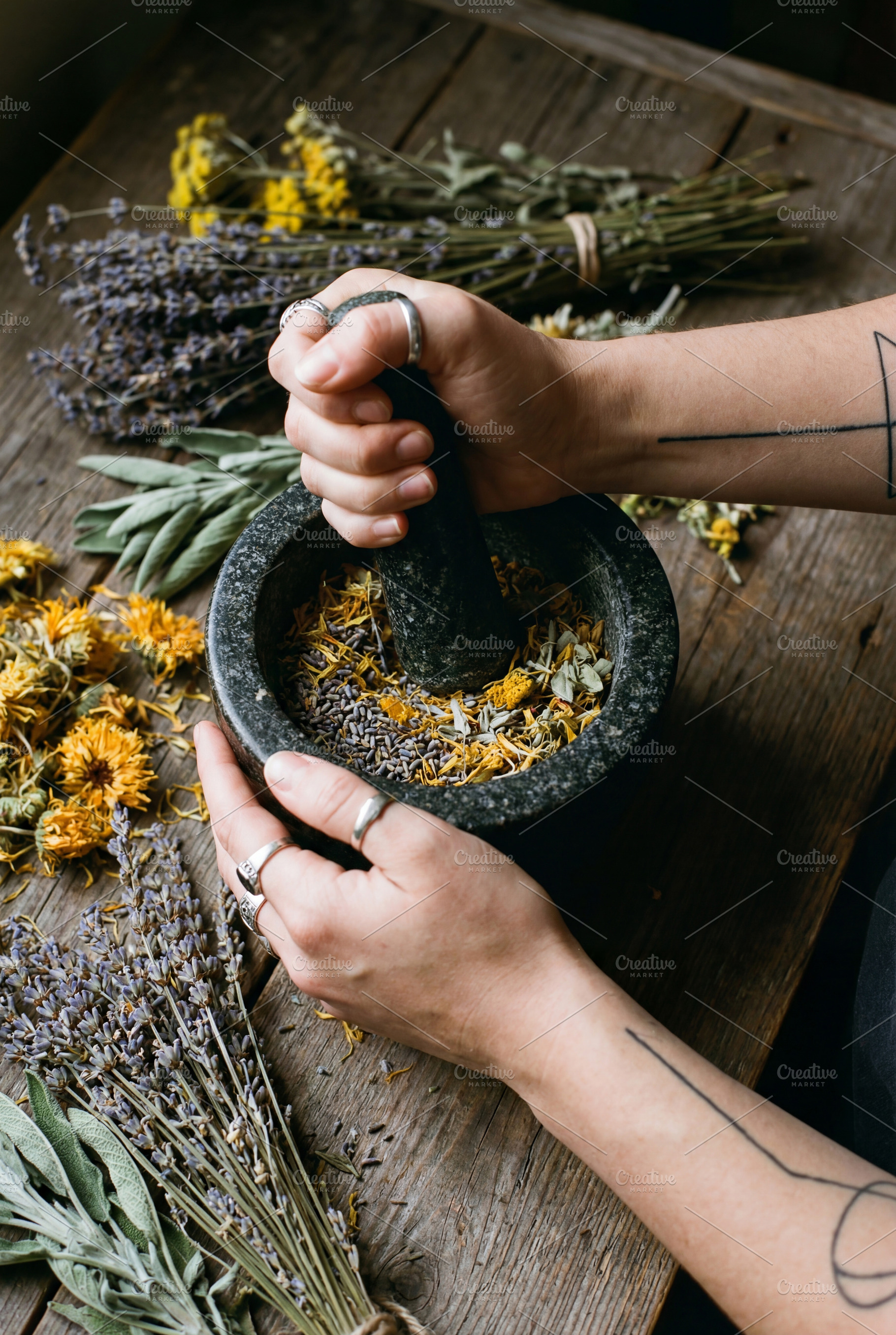 Herbalist Grinding Dried Flowers, a Health & Medical Photo by Virgo Studio