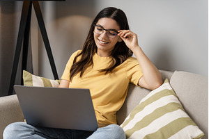 Woman sits comfortably on the couch, a Person Photo by AD Stock Images