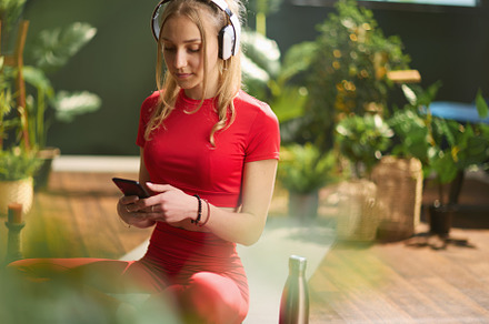 woman in fitness clothes in green house listening to music, a Person Photo by Alliance Images