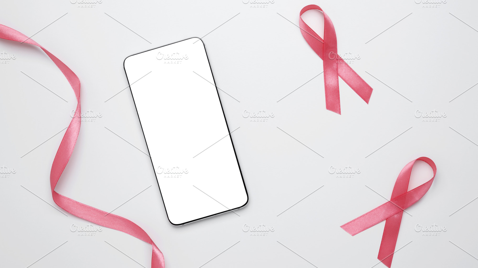 Pink ribbon on smartphone mockup for prevention reminders. Breast cancer awaren, a Photo by matucha