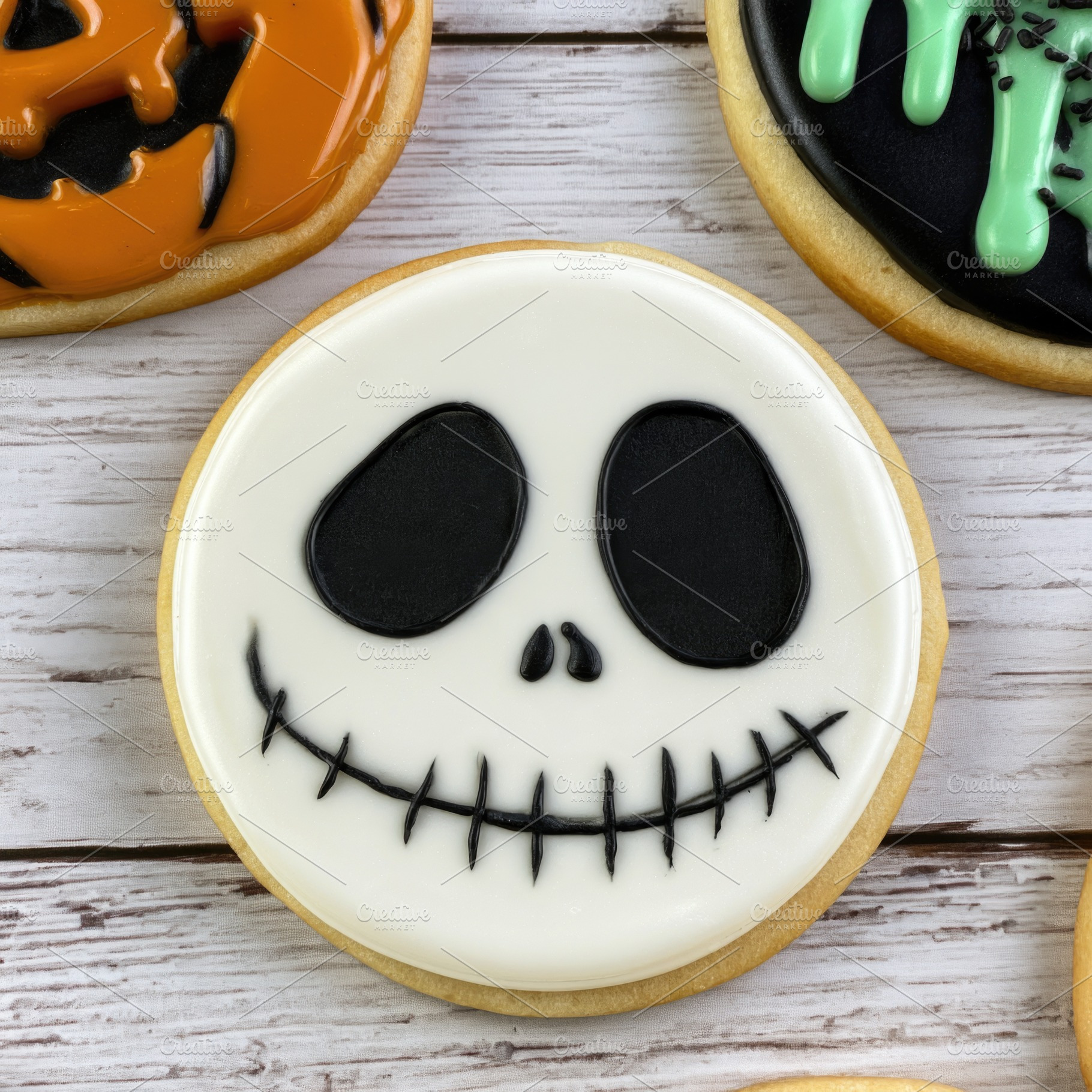 Halloween skull face cookie with black icing on wooden backgroun, a Food & Drink Photo by José Manuel Gelpi