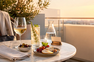 Rooftop dining setup with wine, appe, a Photo by Dvoevnore photos