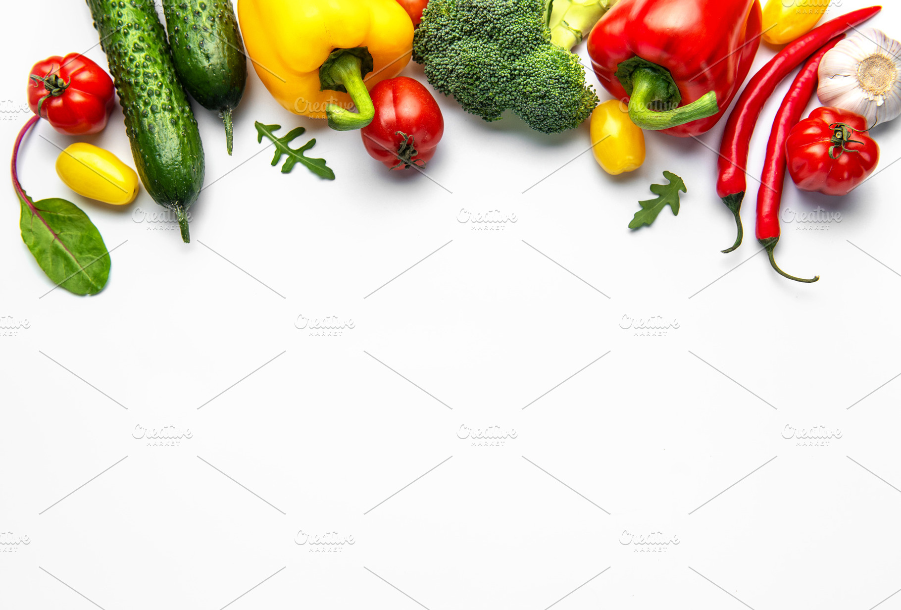 Fresh organic vegetables creating healthy eating border on white, a Food & Drink Photo by Olena Rudo