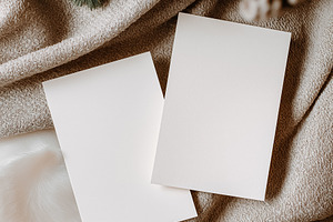 Blank Christmas cards mockup on cozy winter fabrics, creating a festive holiday, a Holiday Photo by Studio ANNA