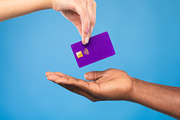 Cropped view of black man taking credit card from millennial woman on blue stud, a Photo by Prostock-Studio (Thumbnail 2 of 2)