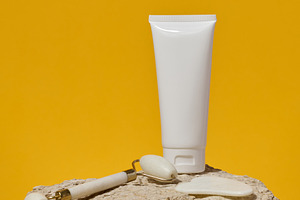 White tube, jade gouache massager and massage jade roller on a y, a Health & Medical Photo by ndanko