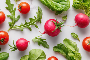 Fresh salad ingredients including lettuce, arugula, radishes, and tomatoes arra, a Food & Drink Photo by AlyaAnd