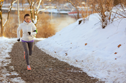 Full length portrait of active woman in white jacket running, a Sports & Recreation Photo by Alliance Images