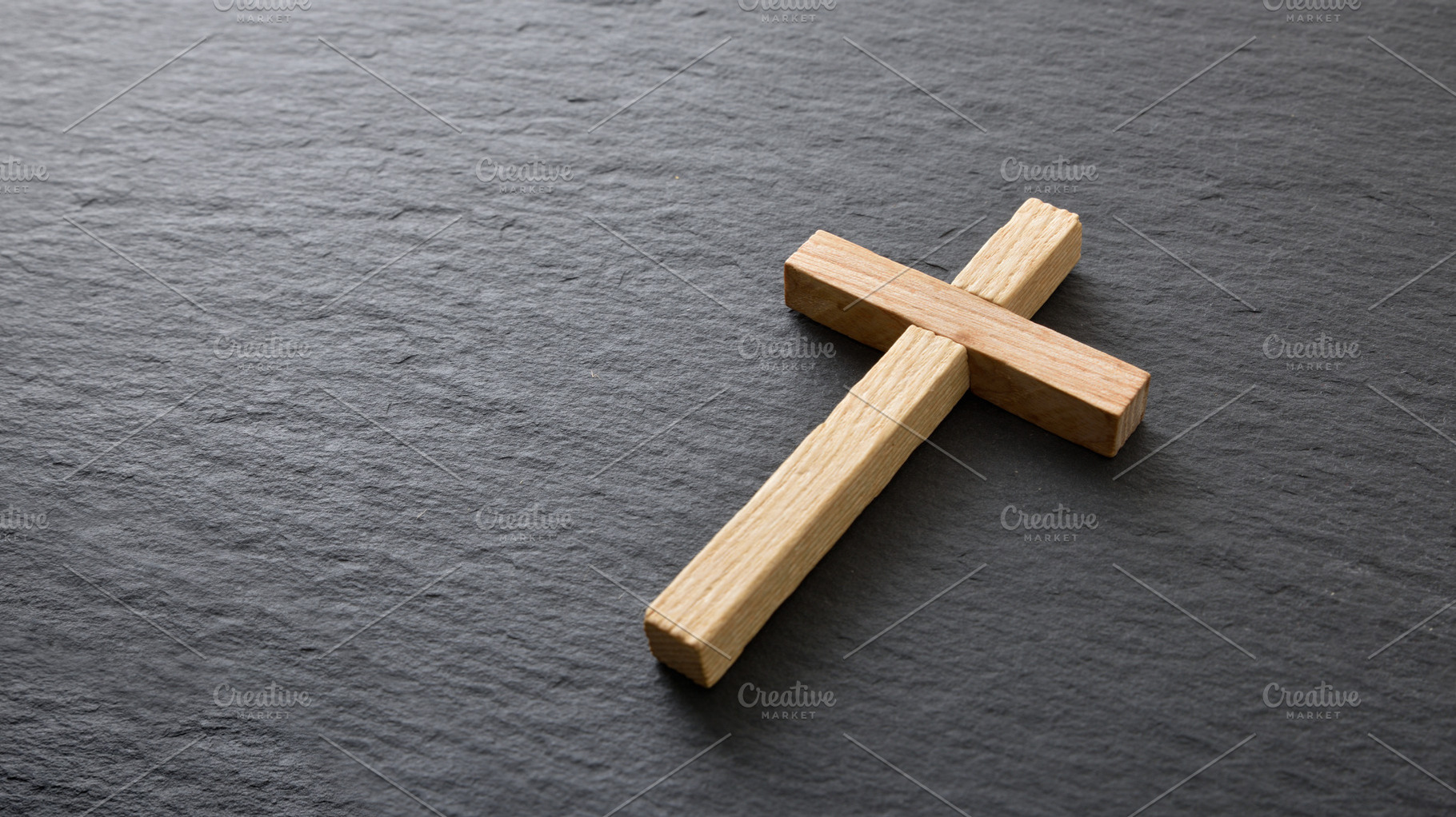 Wooden Cross on Dark Stone Background, a Holiday Photo by Davizro's Market