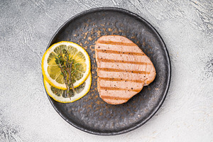 Deliciously charred grilled tuna steak, served with fresh herbs,, a Food & Drink Photo by composter-box@mail.ru