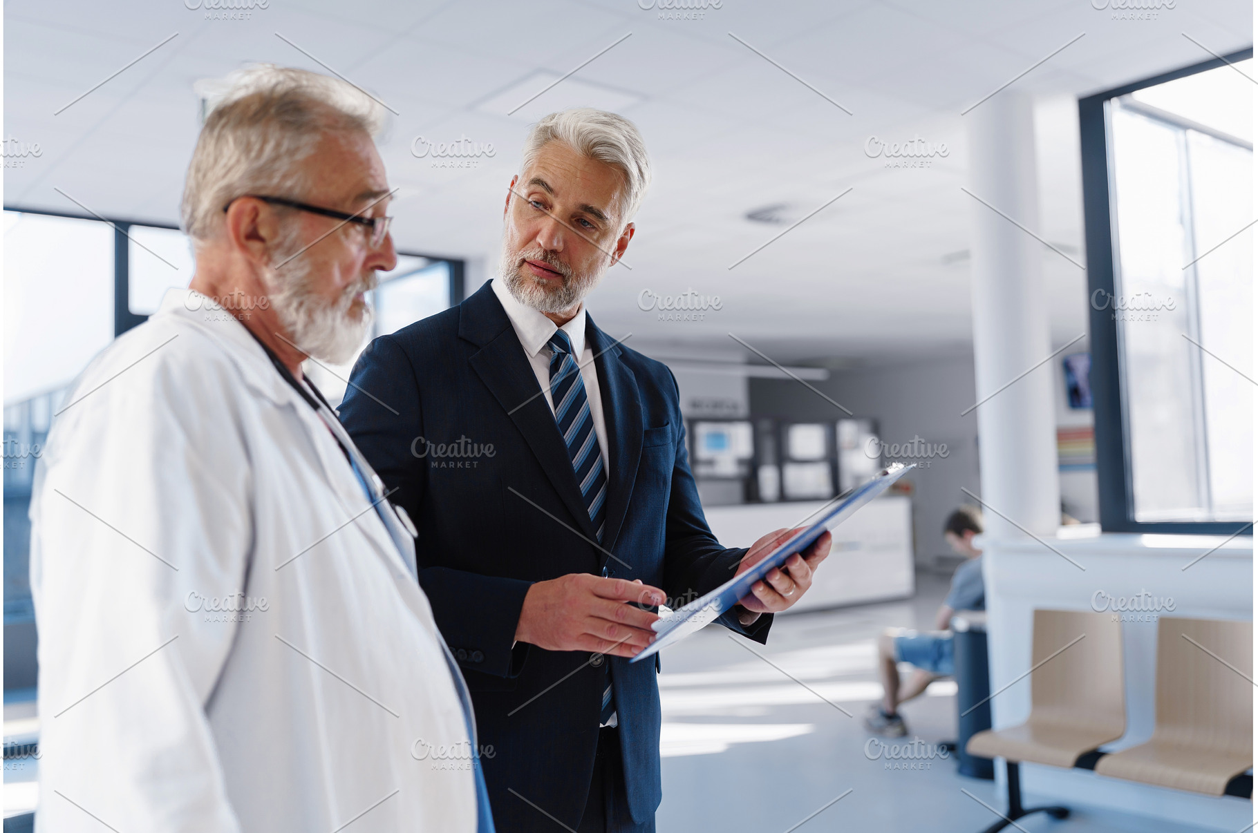 Doctor talking with hospital manager, a Health & Medical Photo by HalfPoint