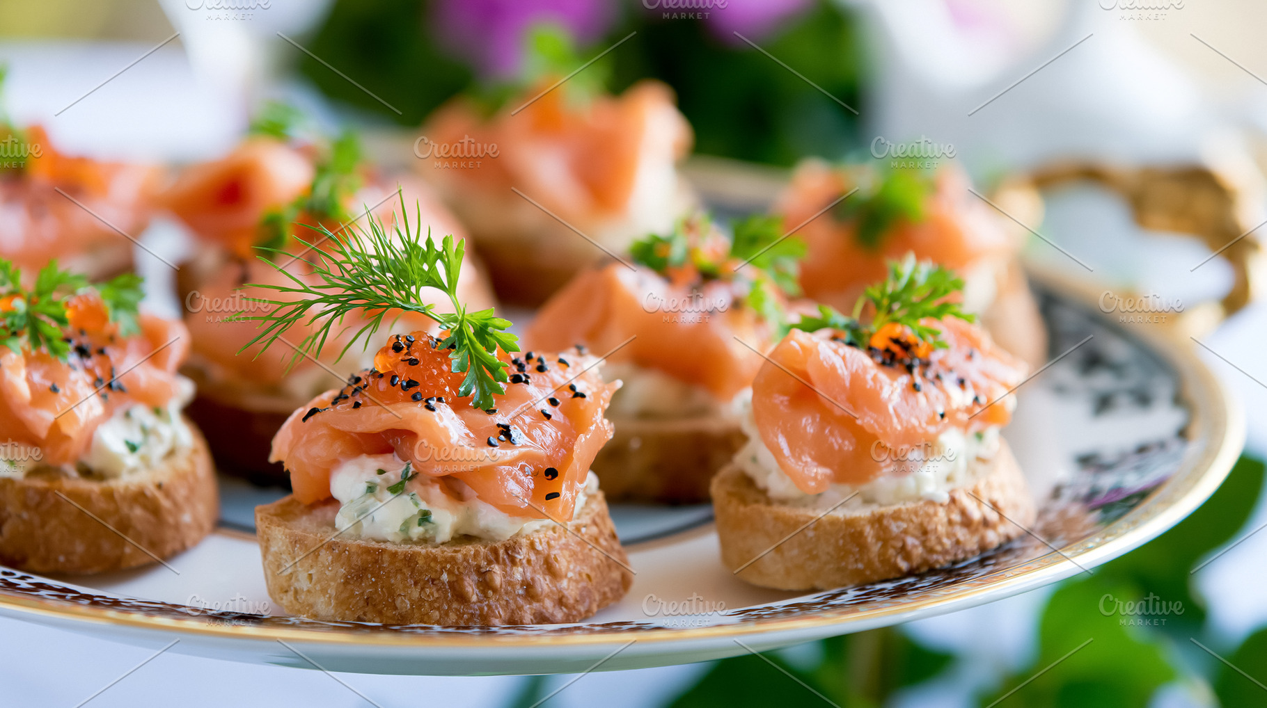 Smoked salmon canapes with cream cheese and dill, garnished with black sesame s, a Photo by Studio ANNA