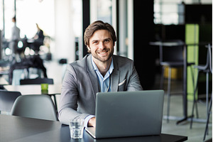 Portrait of businessman working on, a Business Photo by HalfPoint
