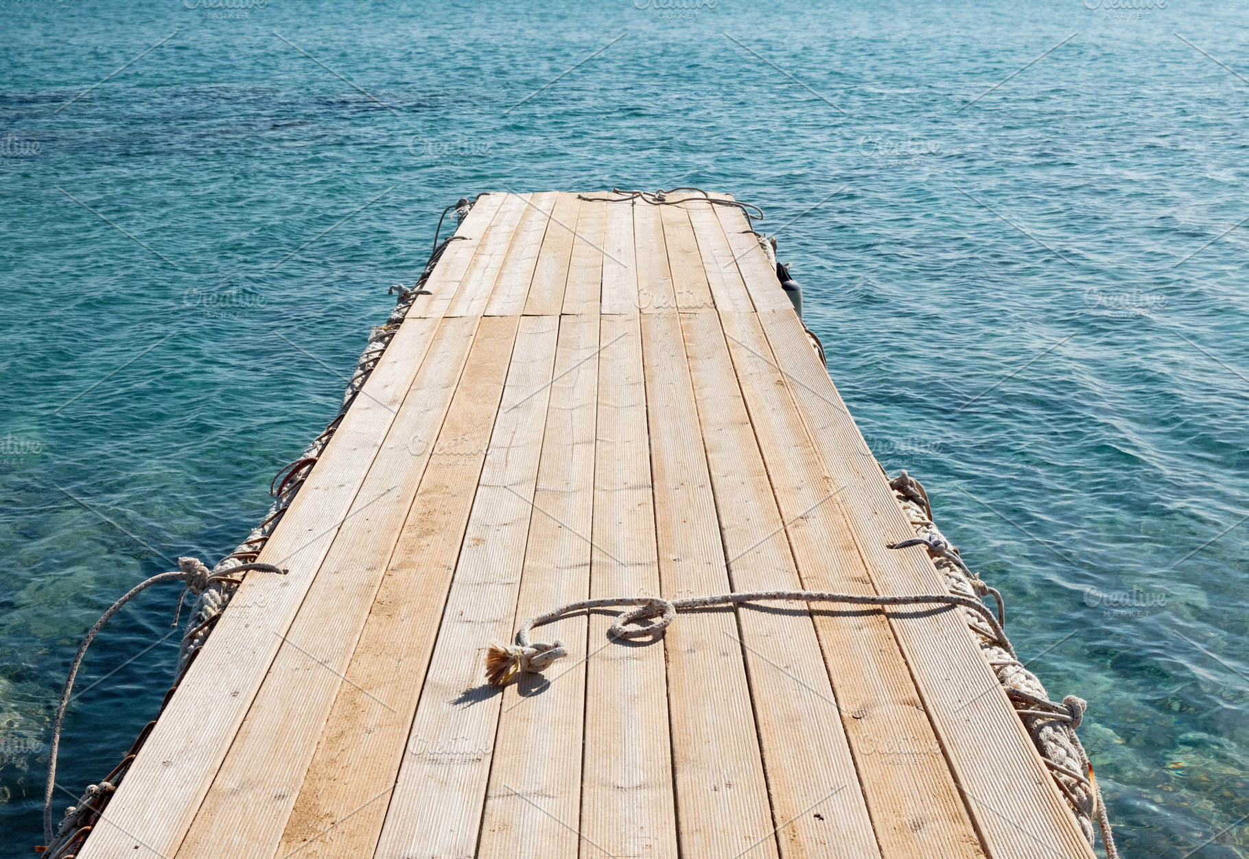 Empty wooden boat dock at the lake, an Industrial Photo by BOOCYS