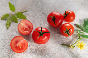 Fresh cherry tomatoes from nature with green leaves, a Food & Drink Photo by Olena Rudo