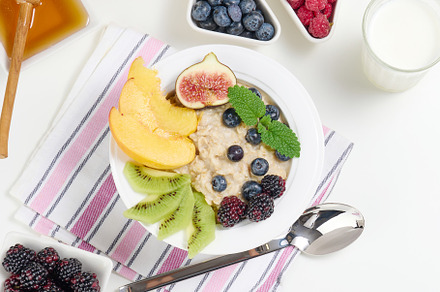 milk, plate with oatmeal porridge and fruit, honey in a bowl on, a Food & Drink Photo by ndanko