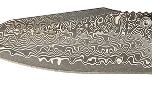 A knife blade with the characteristic wavy and ringed pattern ty, an Abstract Photo by ndanko