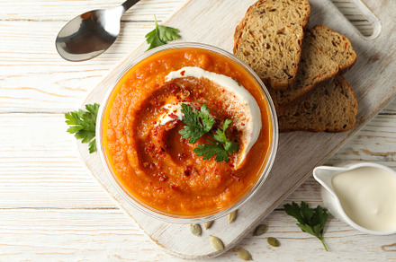 Composition with bowl of pumpkin soup on white wooden background, a Food & Drink Photo by AtlasStudio PRO