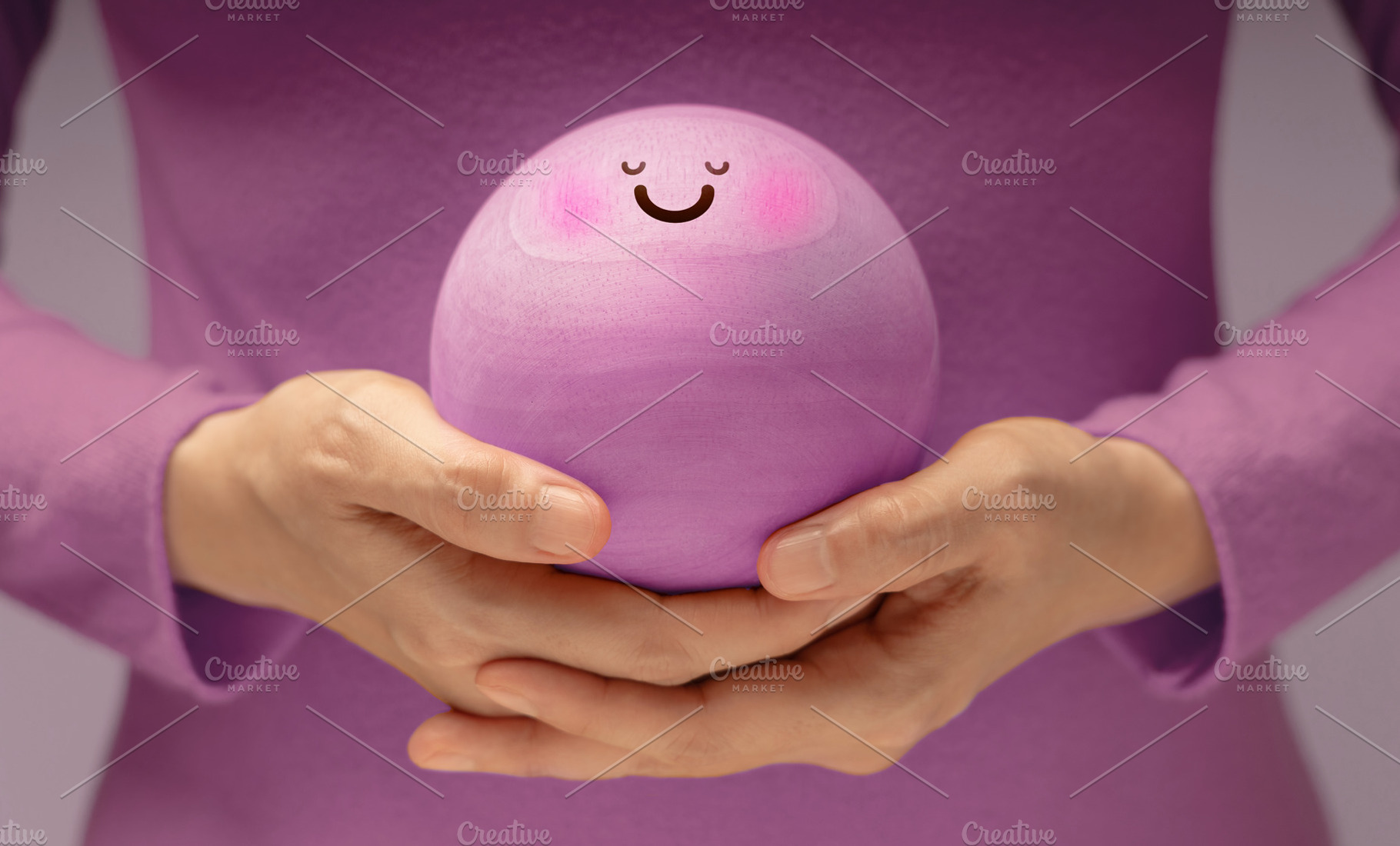Hands gently holding Smiling Circle face. Mental health, emotion, a Photo by salmon.black