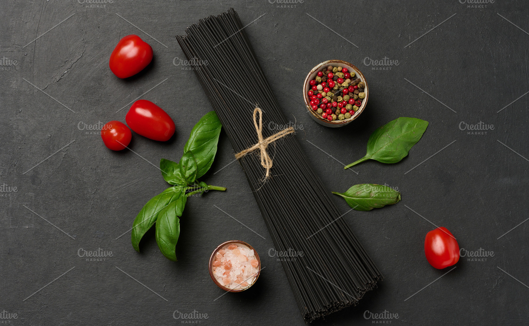 Black spaghetti, sprig of fresh basil, cherry tomatoes, pepper m, a Food & Drink Photo by ndanko