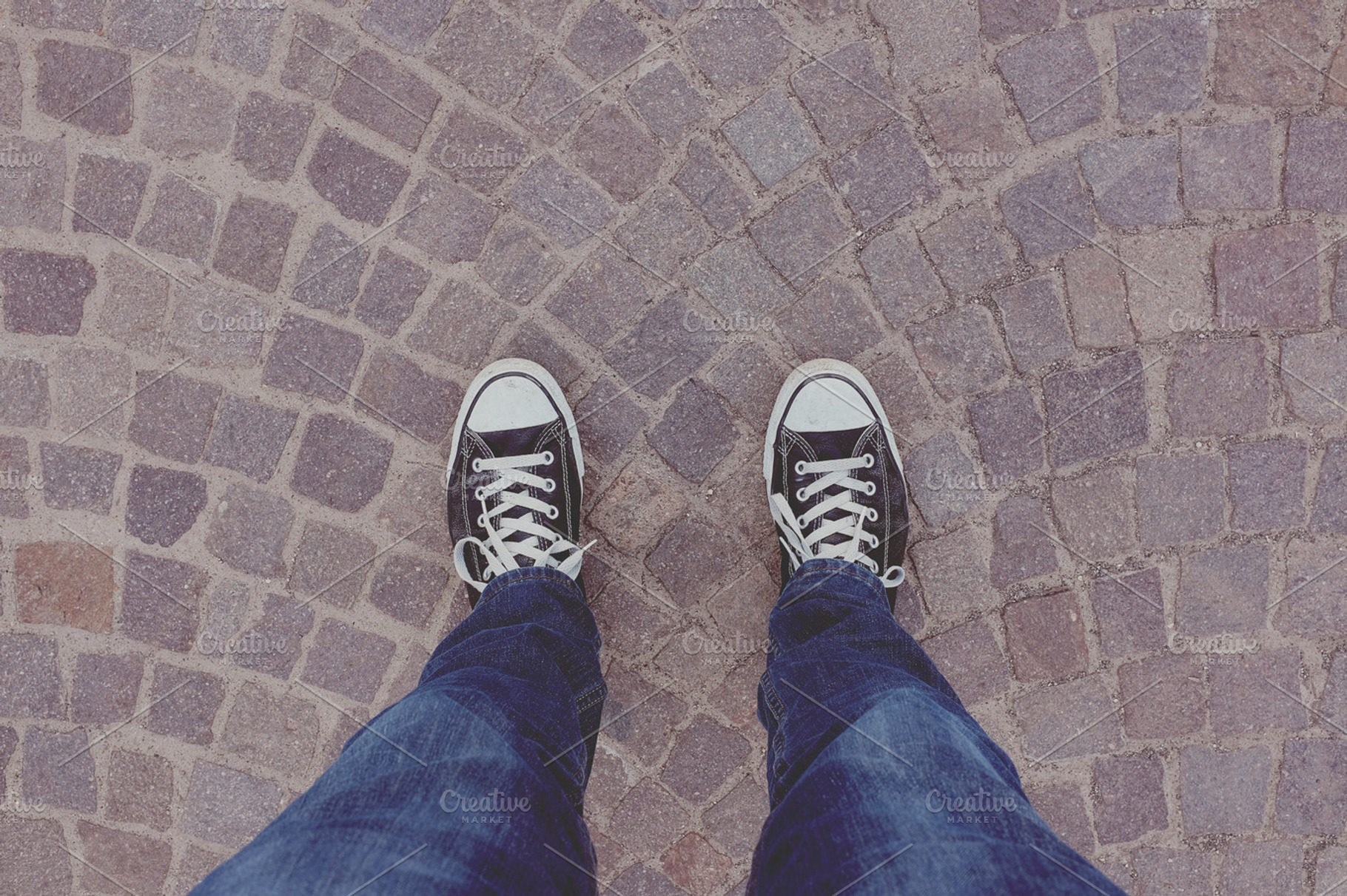 Standing on cobblestone road, a Person Photo by EnjoyLife