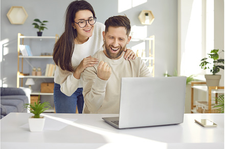 Cheerful young couple using laptop, a Person Photo by StudioRomantic