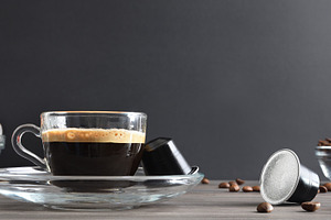 Espresso coffee on wooden table with capsules and isolated backg, a Food & Drink Photo by Davizro's Market