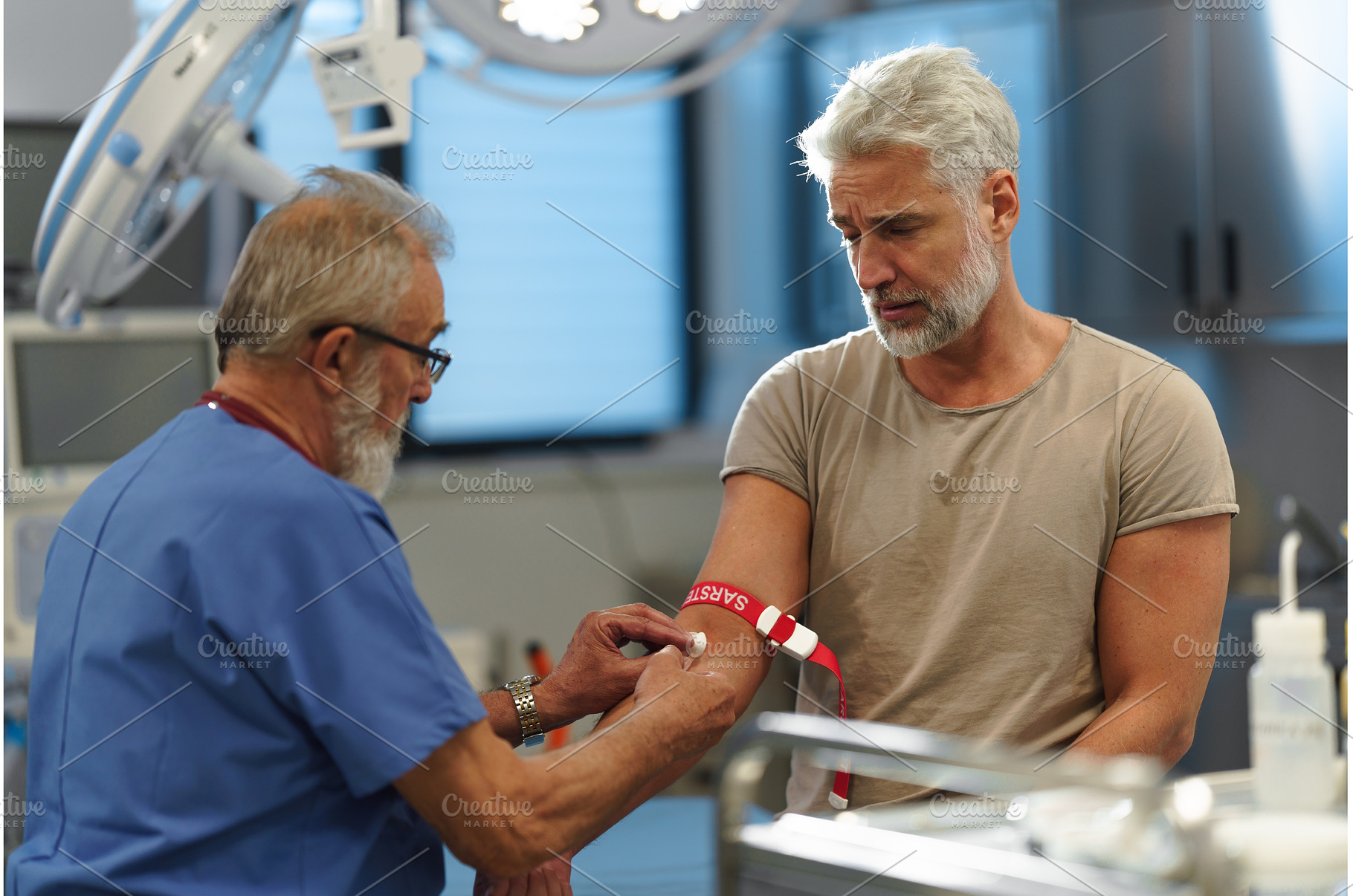 Doctor drawing blood from patient's, a Health & Medical Photo by HalfPoint