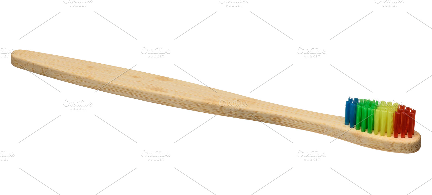 Bamboo toothbrush with bright multi-colored bristles isolated on, a Health & Medical Photo by ndanko
