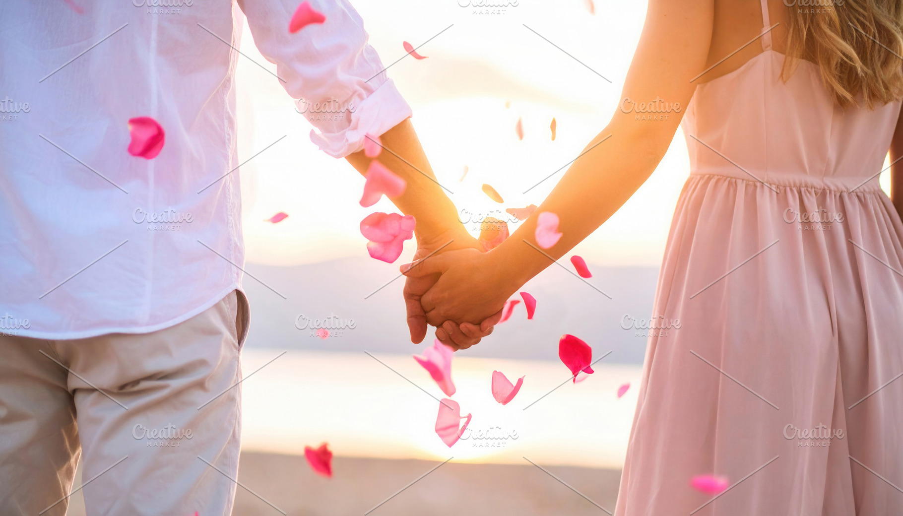 Romantic couple holding hands at sunset beach, a Person Photo by Davizro's Market