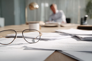 Glasses on papers in a busy office, a Photo by Beautiful things