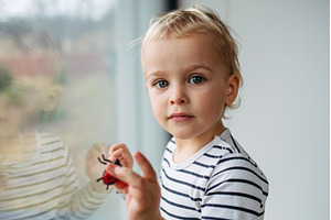 Toddler boy playing with toy ladybug, a Person Photo by HalfPoint