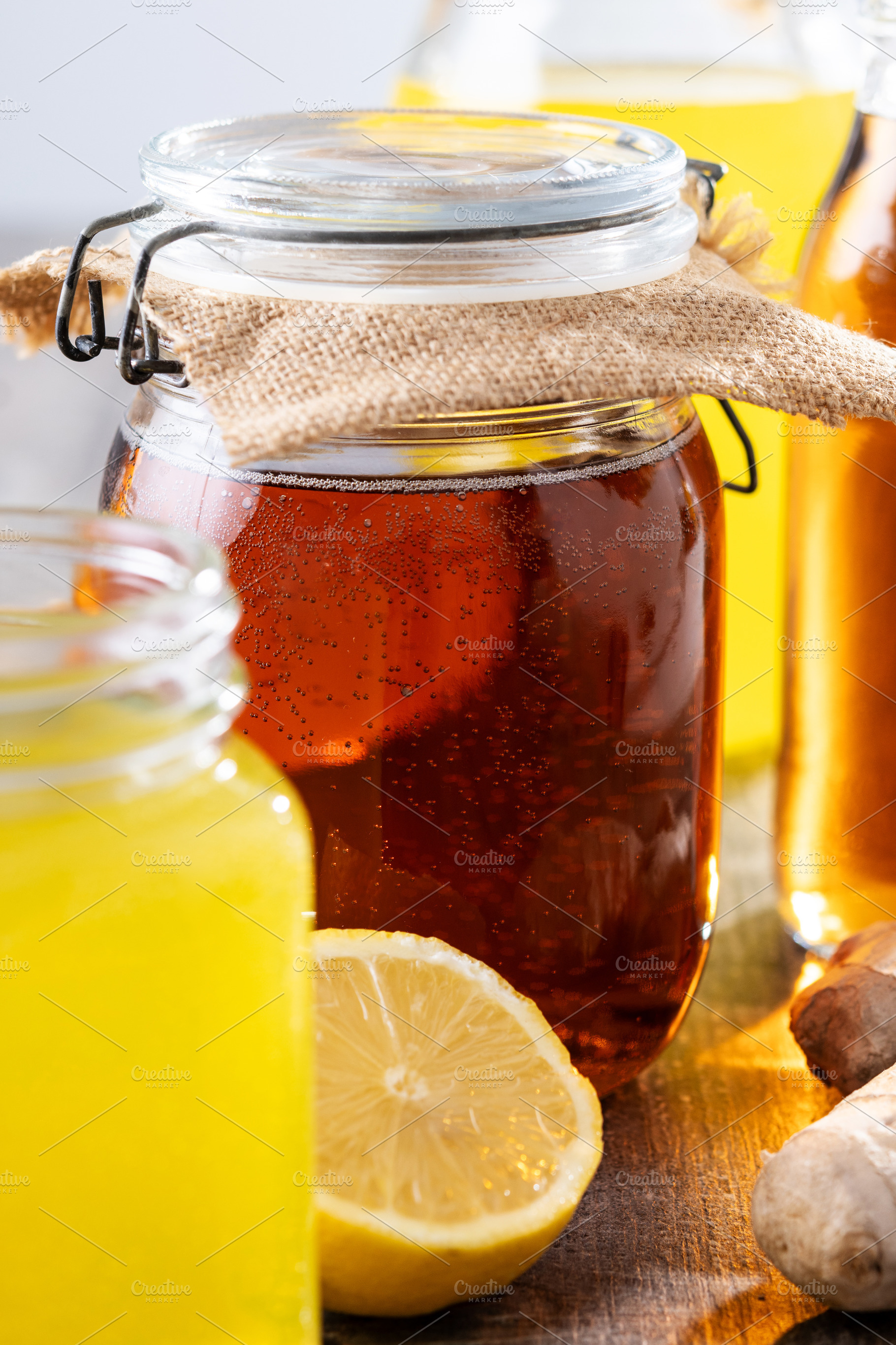 Colorful Kombucha Jars and Bottles on wooden table, a Food & Drink Photo by etorres69