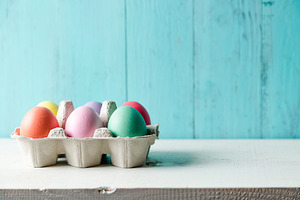 Pastel colored easter eggs in a egg stock photo containing easter and eggs