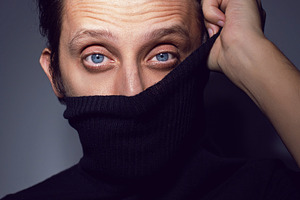 Fashion Portrait of a 35 year old man standing over a light gray background in