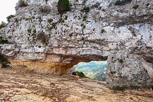 wide shot of La Foradada rock arch in Spain, a Photo by Nito