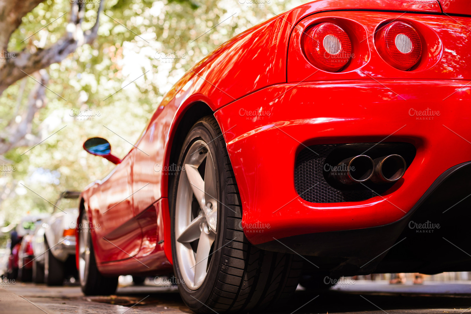 Back view of a red ferrari featuring fashion, car, and design, a Transportation Photo by BodiaPhoto