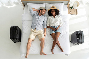 Happy Couple Relaxing on Bed with Suitcases, a Sports & Recreation Photo by Davizro's Market